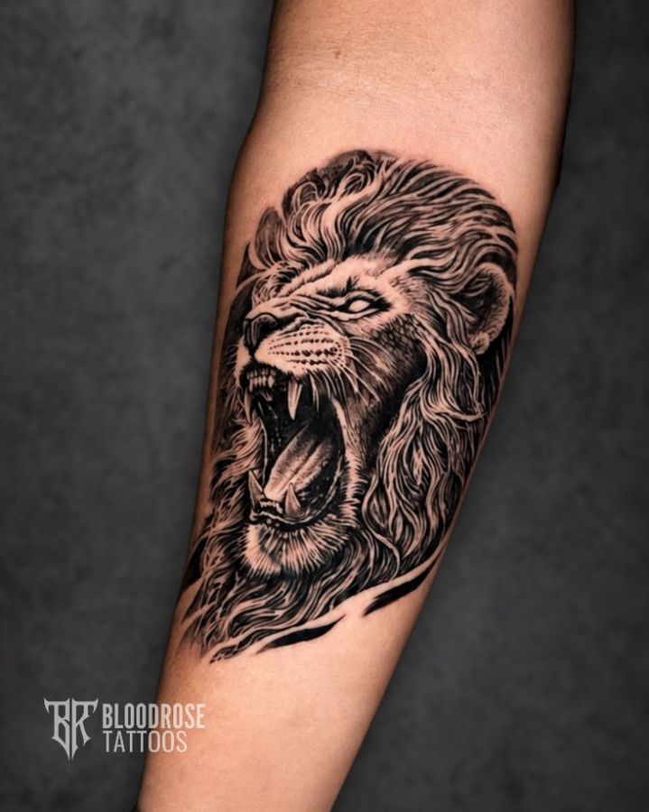 Roaring lion tattoo in black and grey