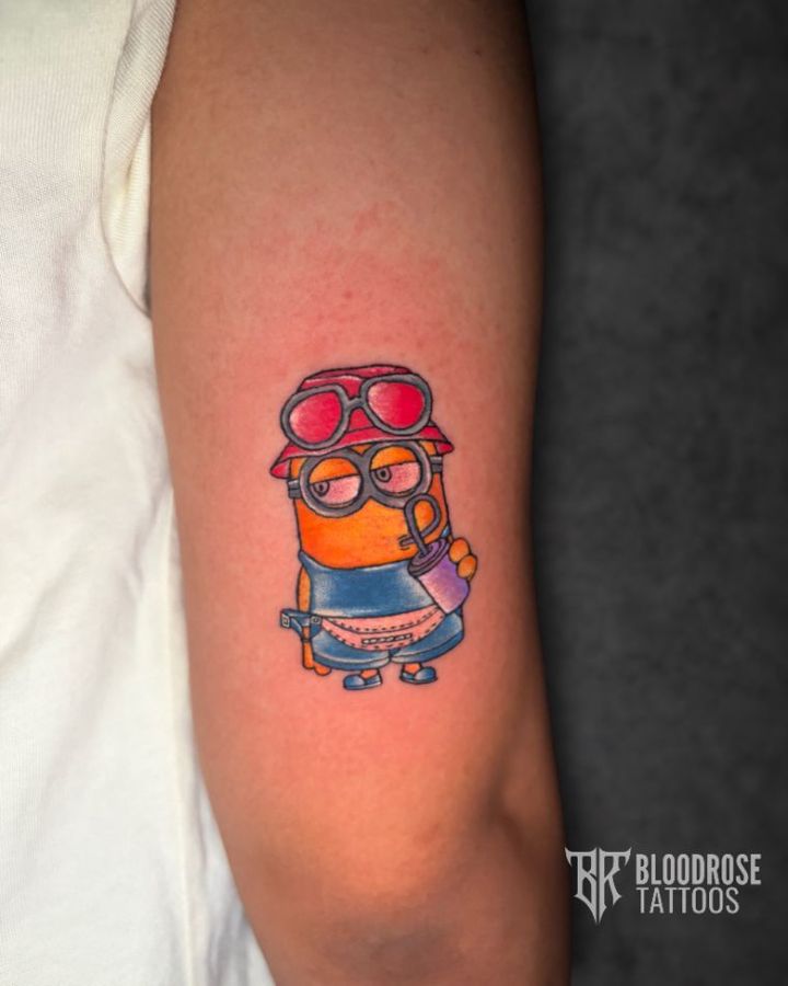 Colour Minion-inspired tattoo on a forearm